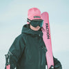 Skier wearing Faction skis logo beanie in pink