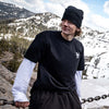 Faction freestyle skier walking wearing Faction t-shirt